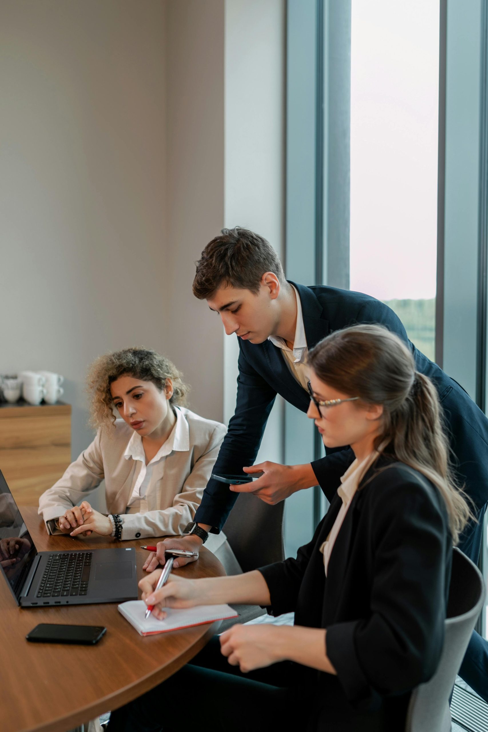 Business team collaborating around a laptop